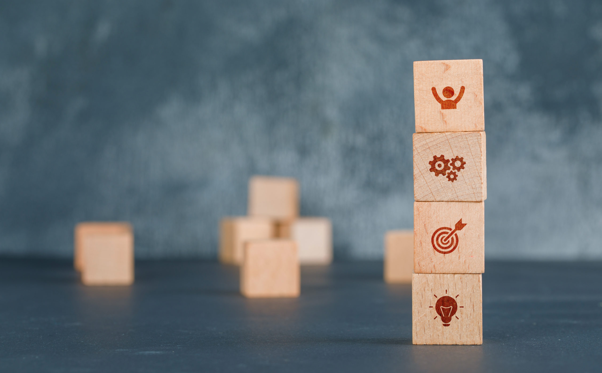 Conceptual business with wooden blocks column with icons